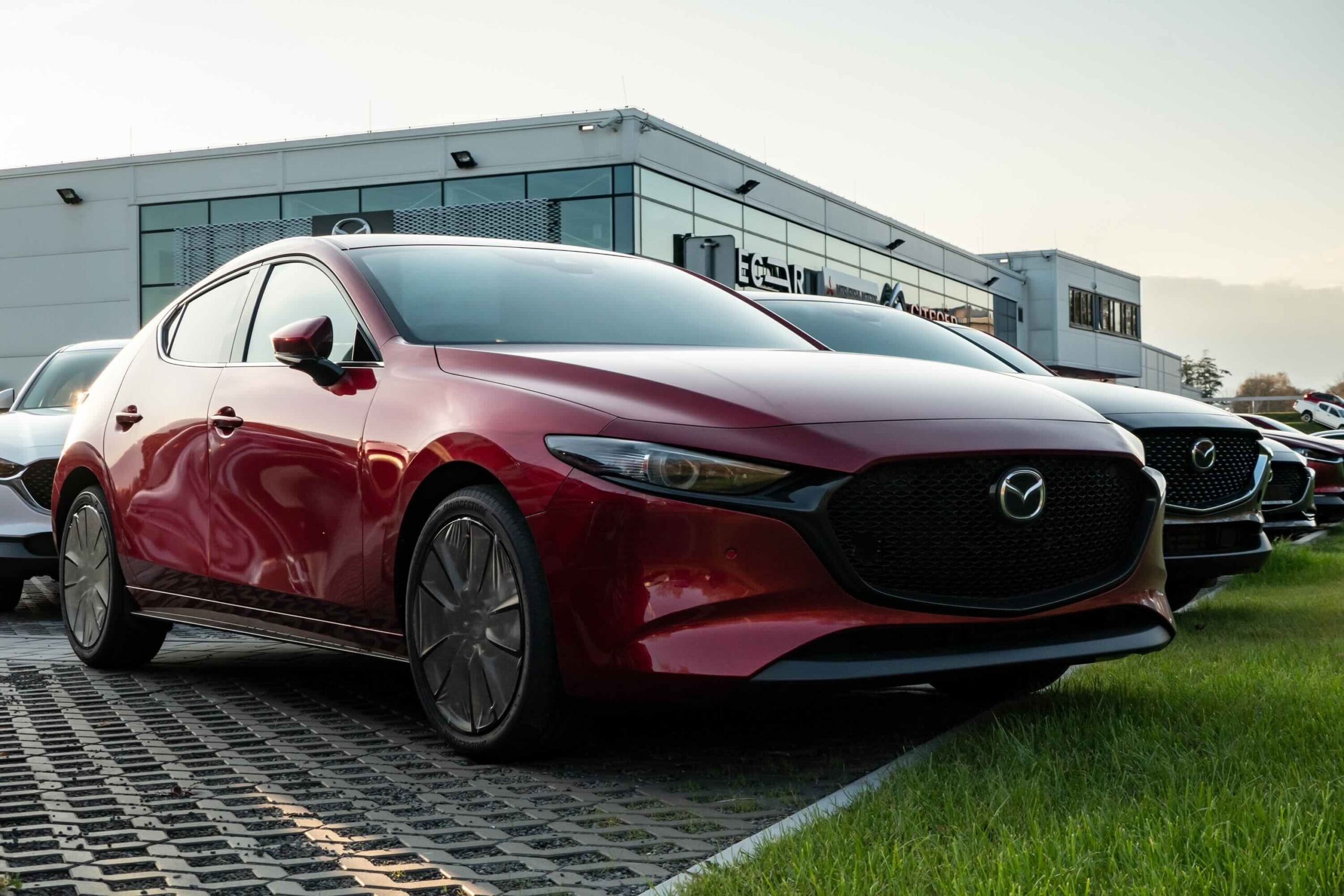 Brand new red Japanese Mazda 3 hatchback car of the 2019 and 2020 model year presented outside the showroom of a dealership